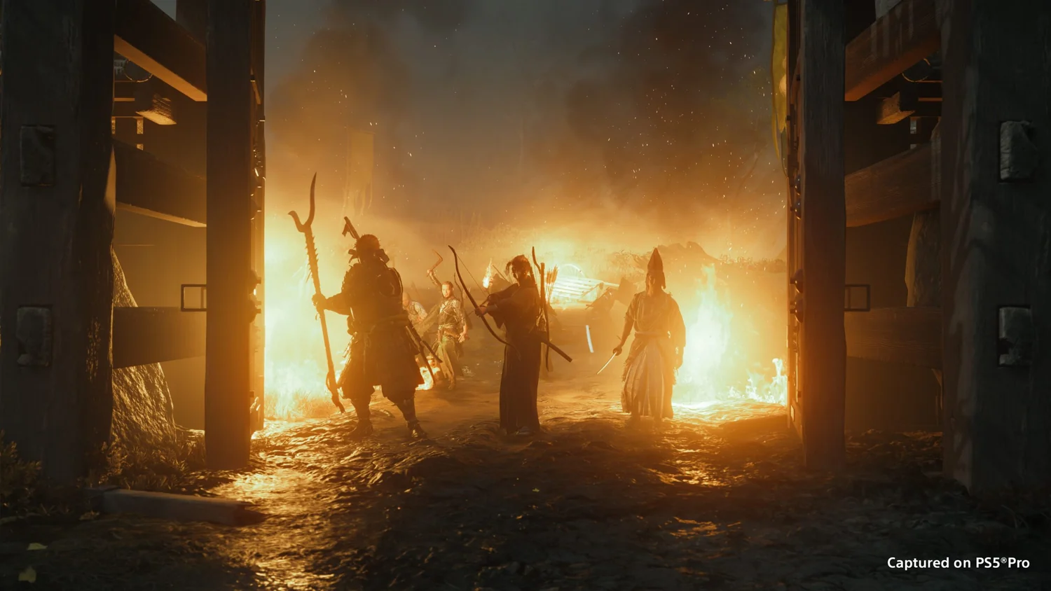 People silhouetted inside a burning building