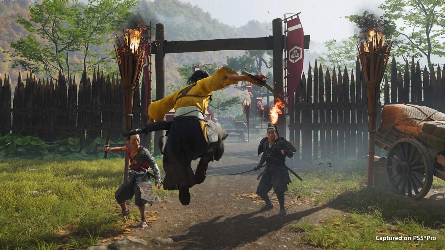 Atsu fighting near a fortified gate in an official Ghost of Yōtei screenshot