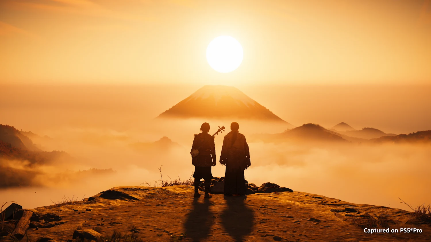 Atsu and another character overlooking Mount Yōtei in official expansion artwork